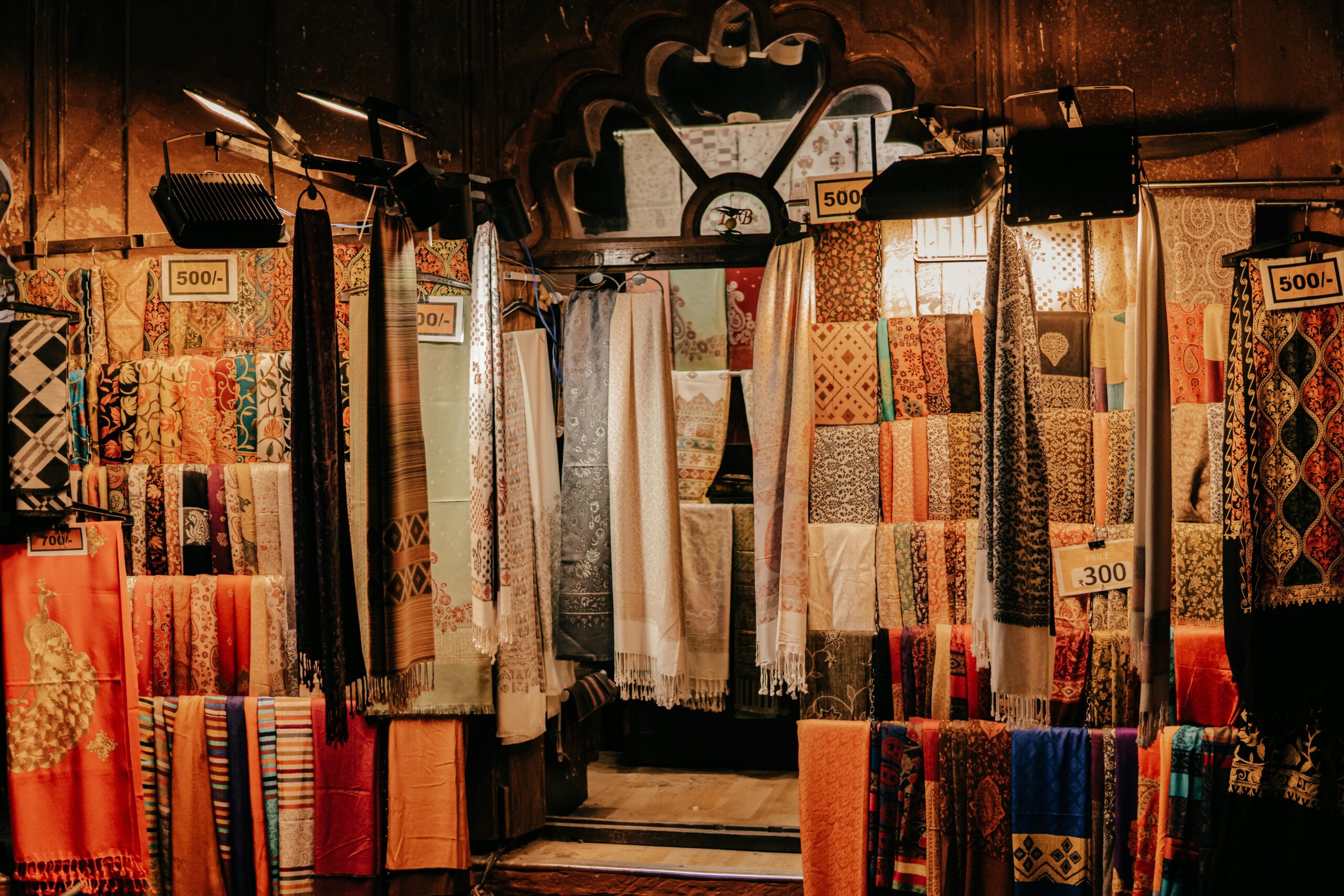 Vibrant textiles and fabrics on display at a bazaar in New Delhi, India.