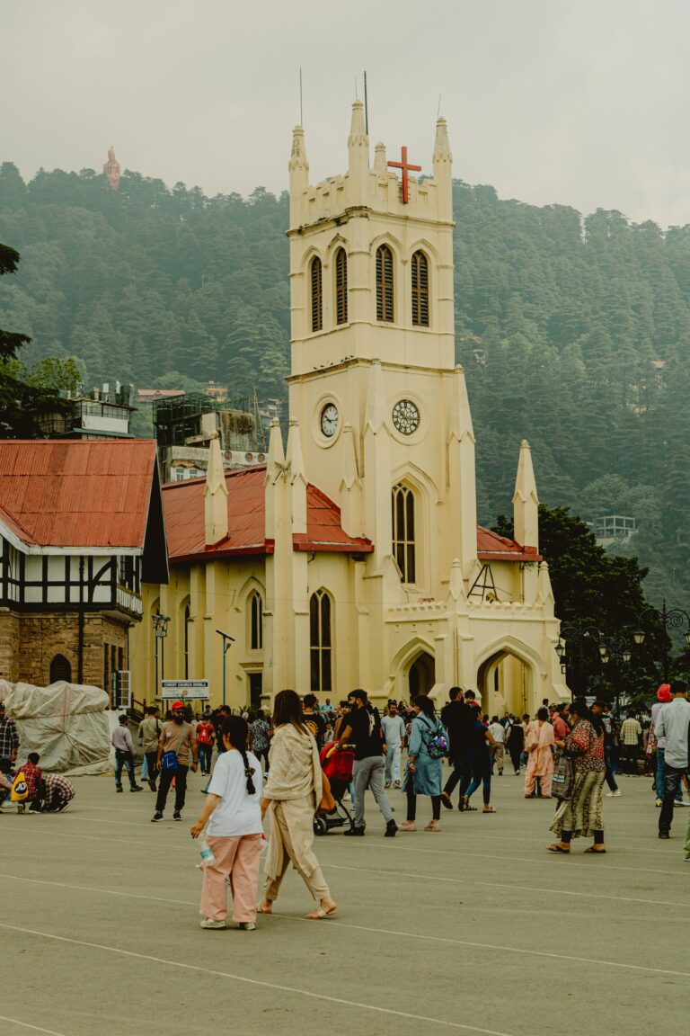 Mall Road in Shimla with colonial-era buildings, shops, and tourists walking along the pedestrian street in the Himalayas